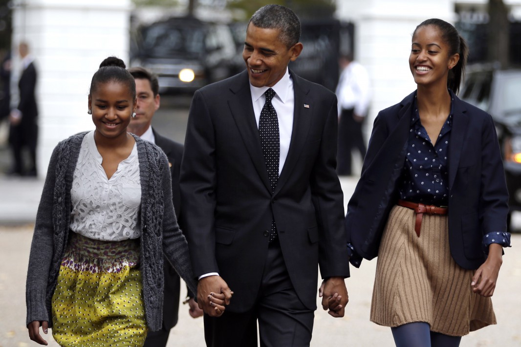 President Barack Obama walks to St. John's Episcopal Church from the White House with his daughters Sasha, left, and Malia, in Washington, on Sunday, Oct. 28, 2012.  (AP Photo/Jacquelyn Martin)